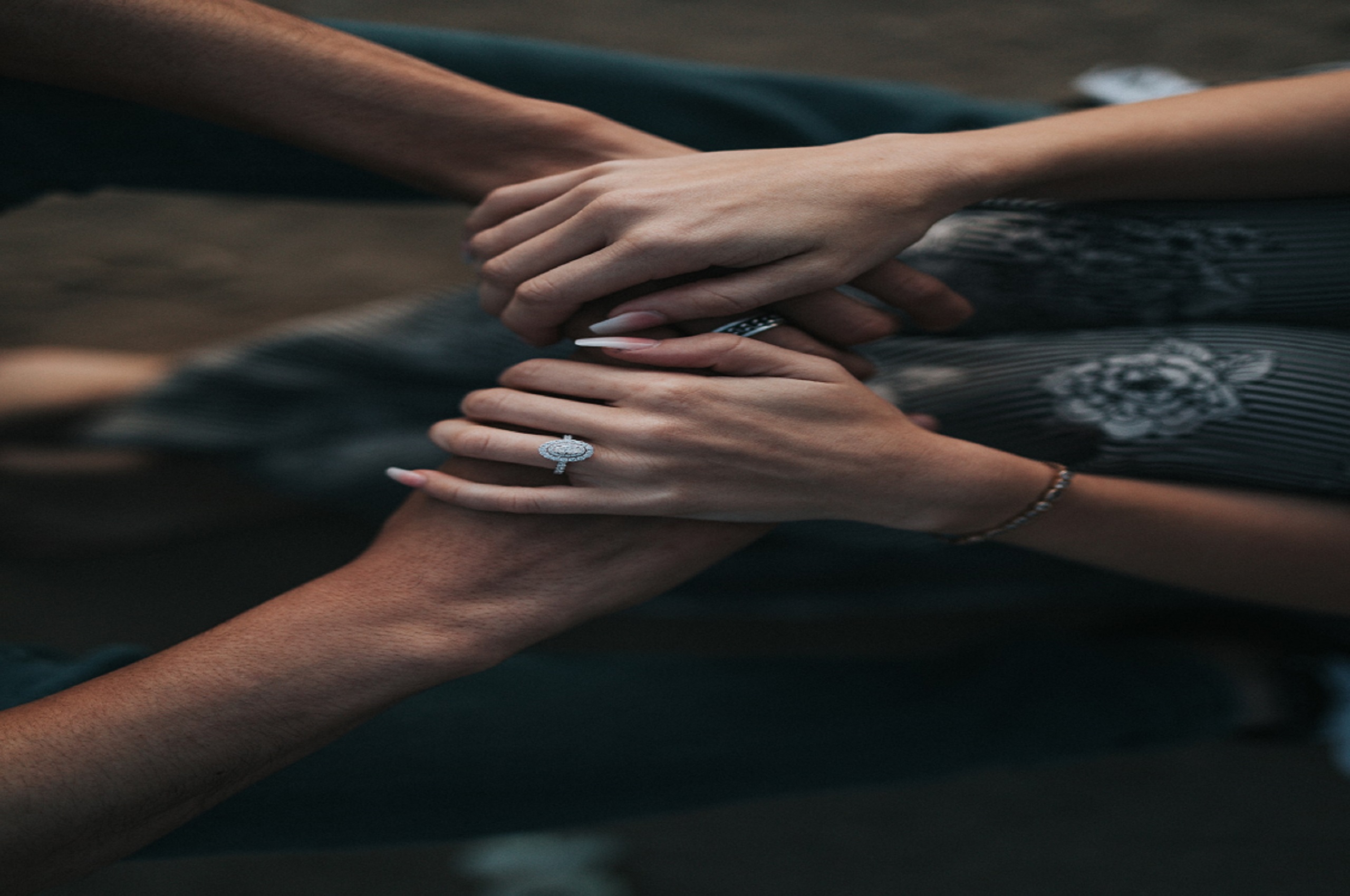 man and woman handing hands wearing wedding rings